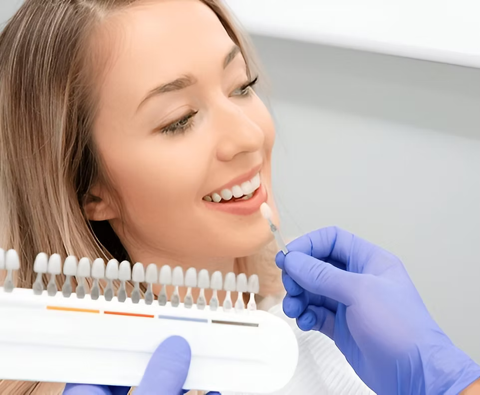 Woman smiling during tooth shade matching for dental implants