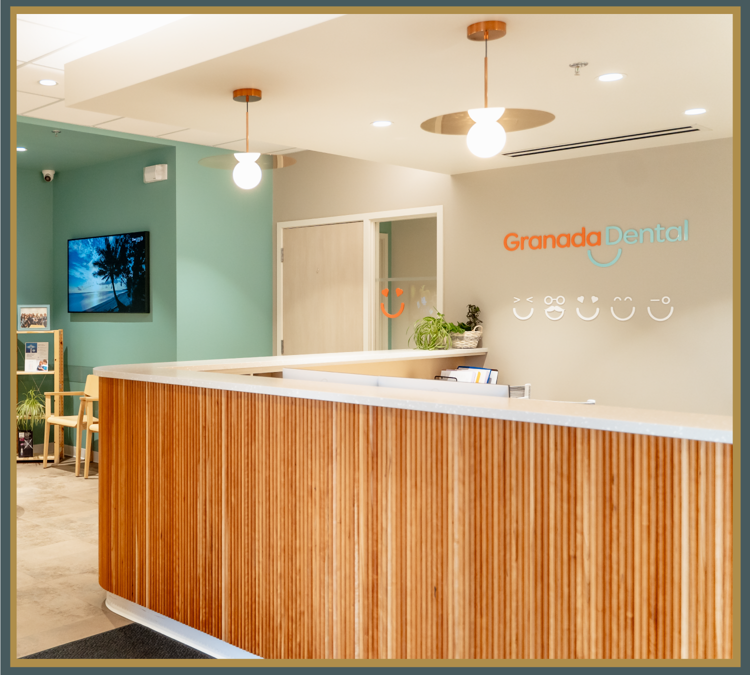 Granada Dental front desk reception area with modern design and logo on the wall